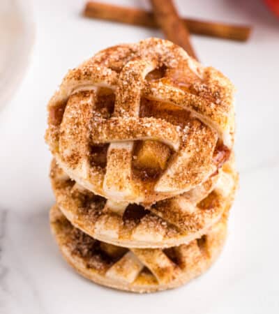 Apple pie cookies stacked on top of one another