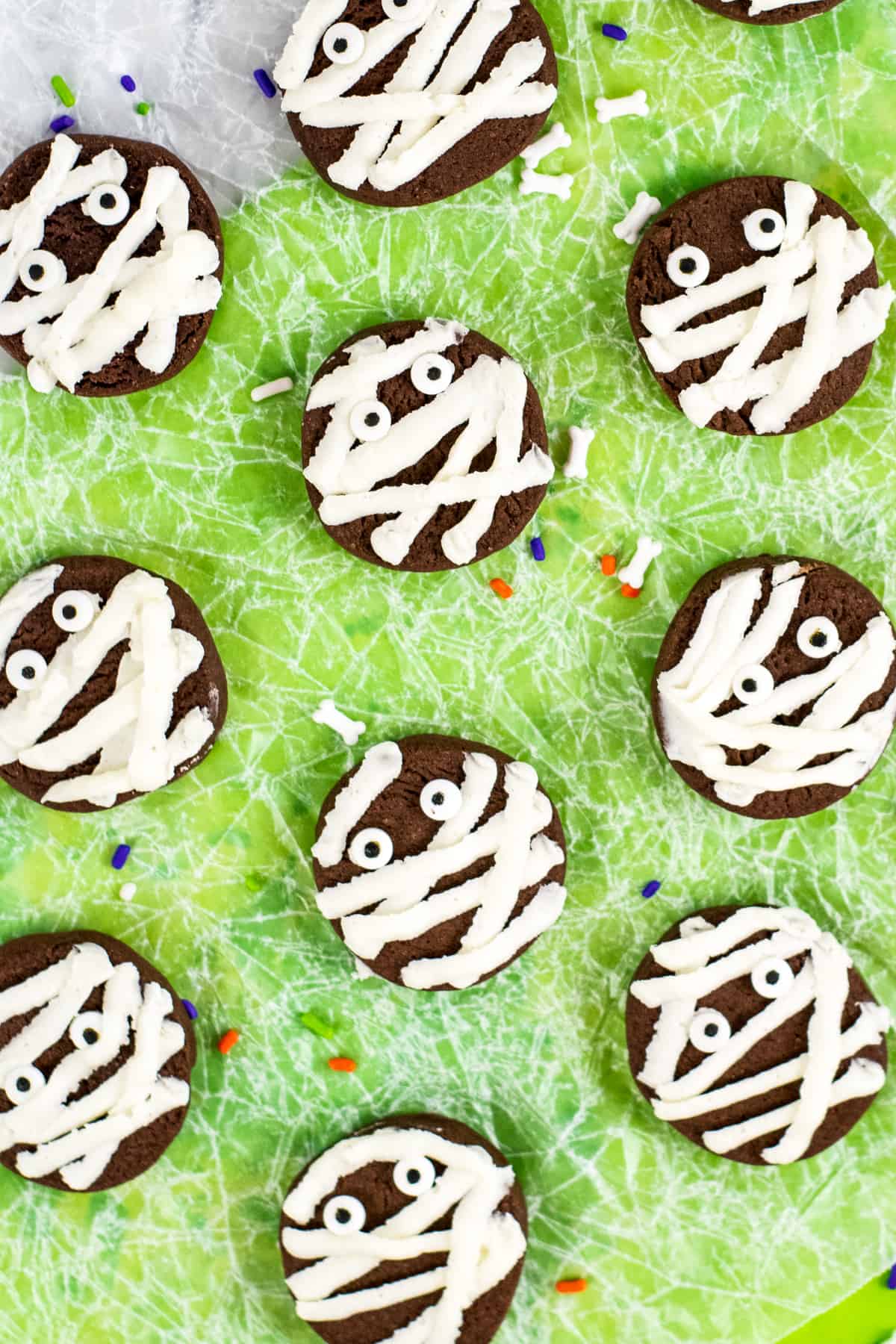 chocolate mummy cookies with vanilla frosting and candy eyeballs