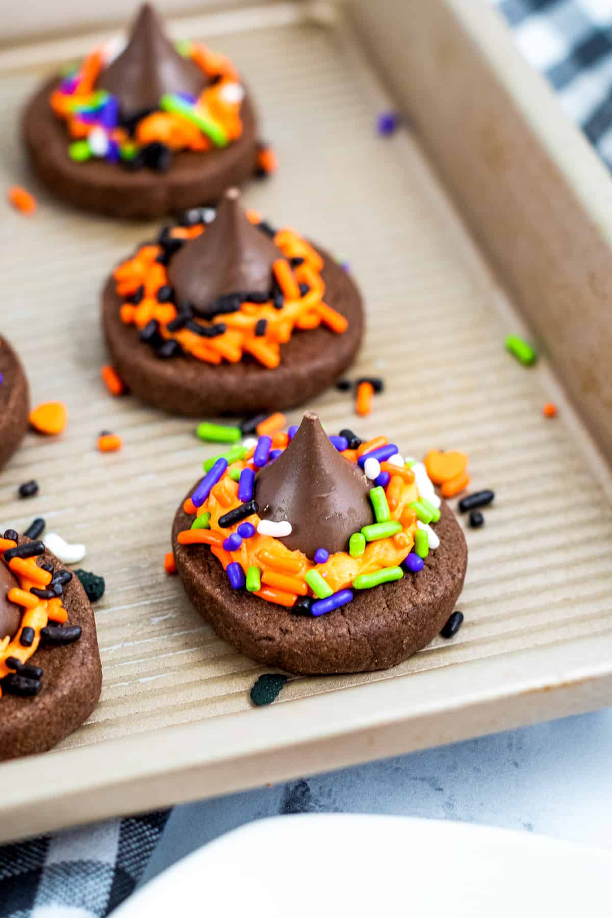 Chocolate witch hat cookies made with chocolate cookies and Hershey kisses