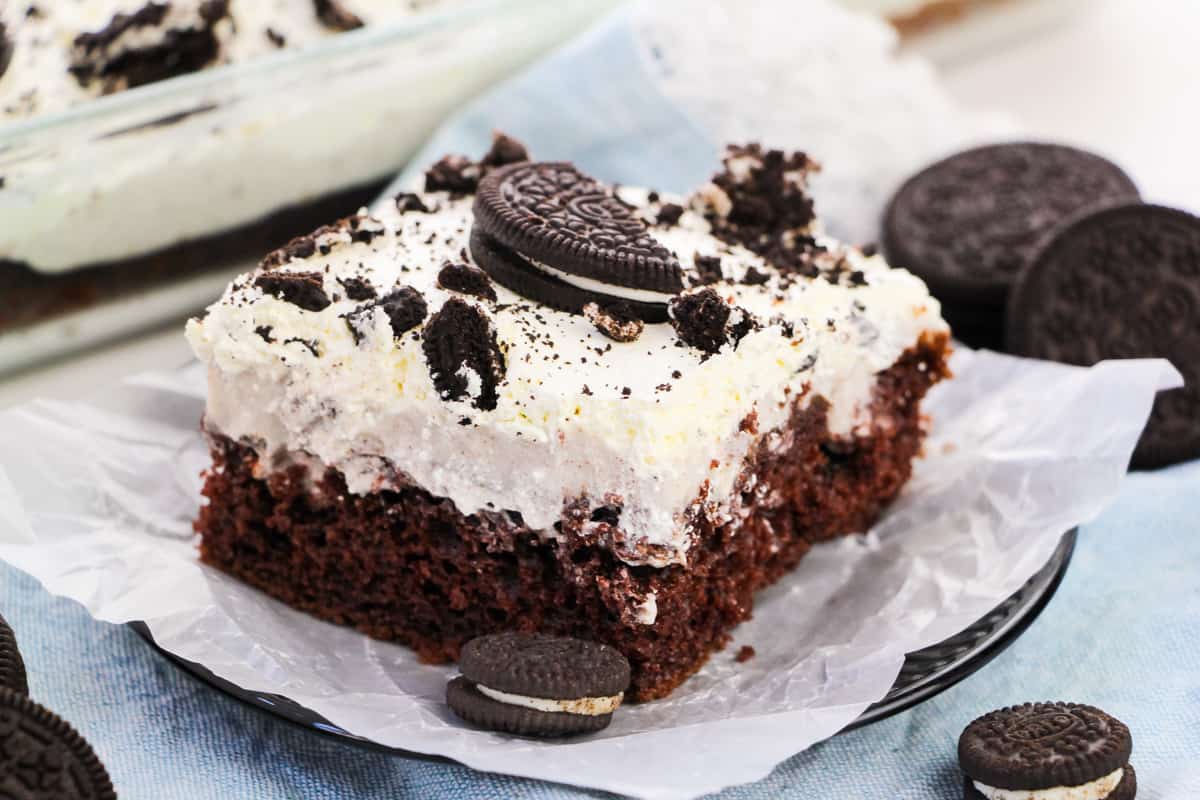 OREO Poke Cake topped with Cool Whip and crumbled OREO cookies