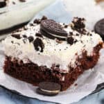 OREO Poke Cake topped with Cool Whip and pieces of OREOs