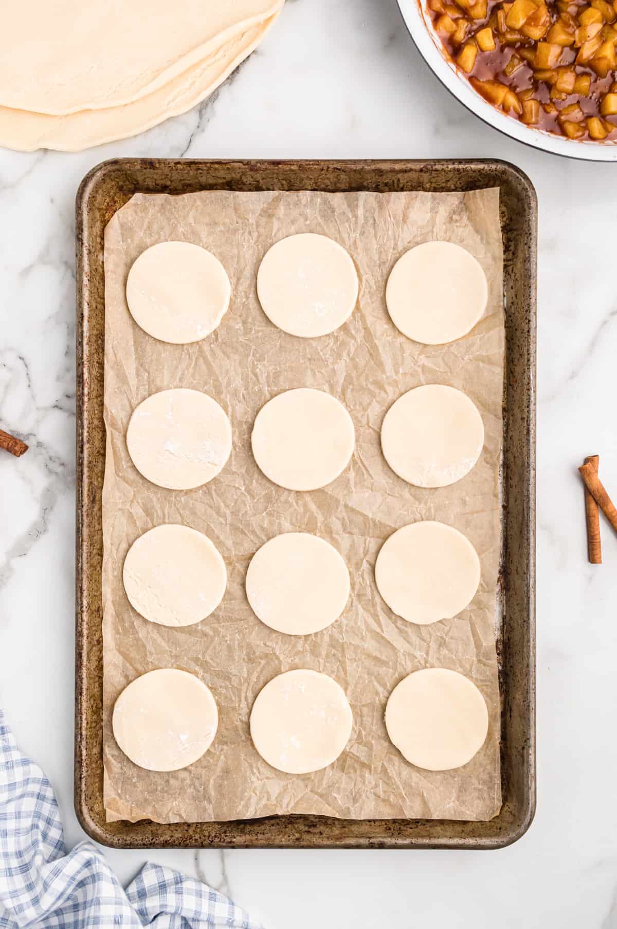 Pie crust circles laid evenly and about 1 inch apart on parchment-lined on baking sheet