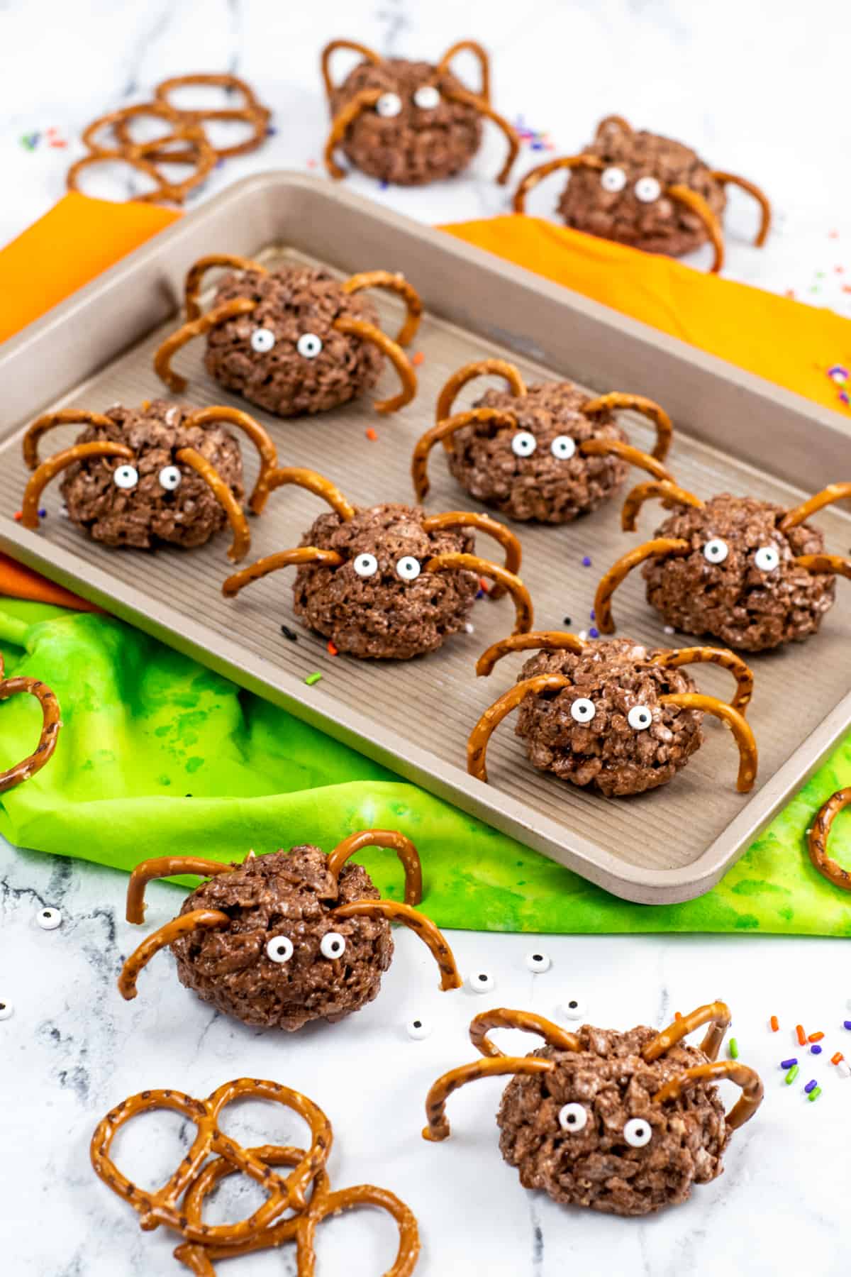 Spider-shaped rice cereal treats with pretzels as legs and edible candy eyes