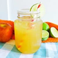 Apple Cider Margarita in mason jar with sugared rim and lime garnish