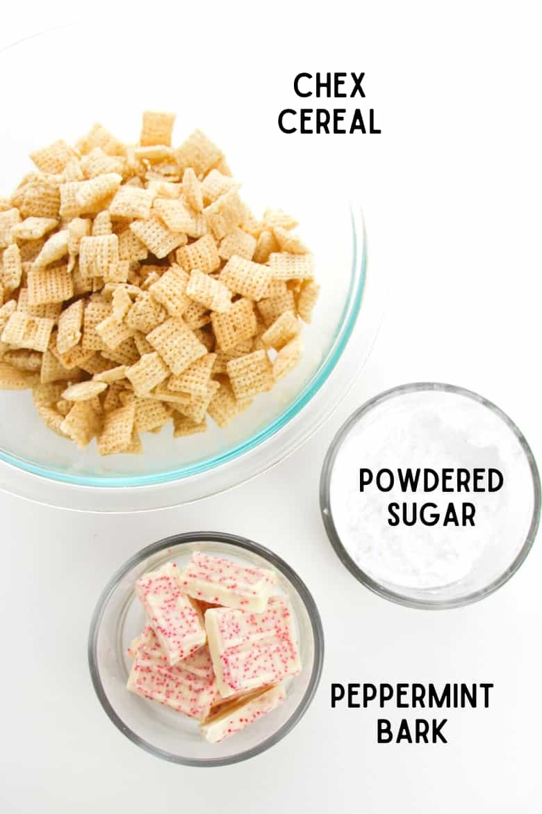 large glass bowl of chex cereal, small glass bowl of peppermint bark and small glass bowl of powdered sugar