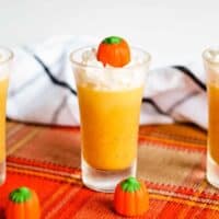 Pumpkin jello shot topped with whipped cream and candy pumpkin