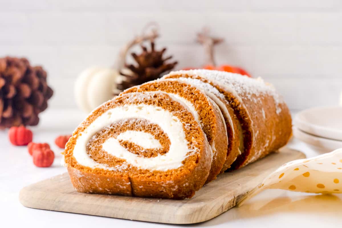 pumpkin roll with swirl of cream cheese filling and dusting of powdered sugar