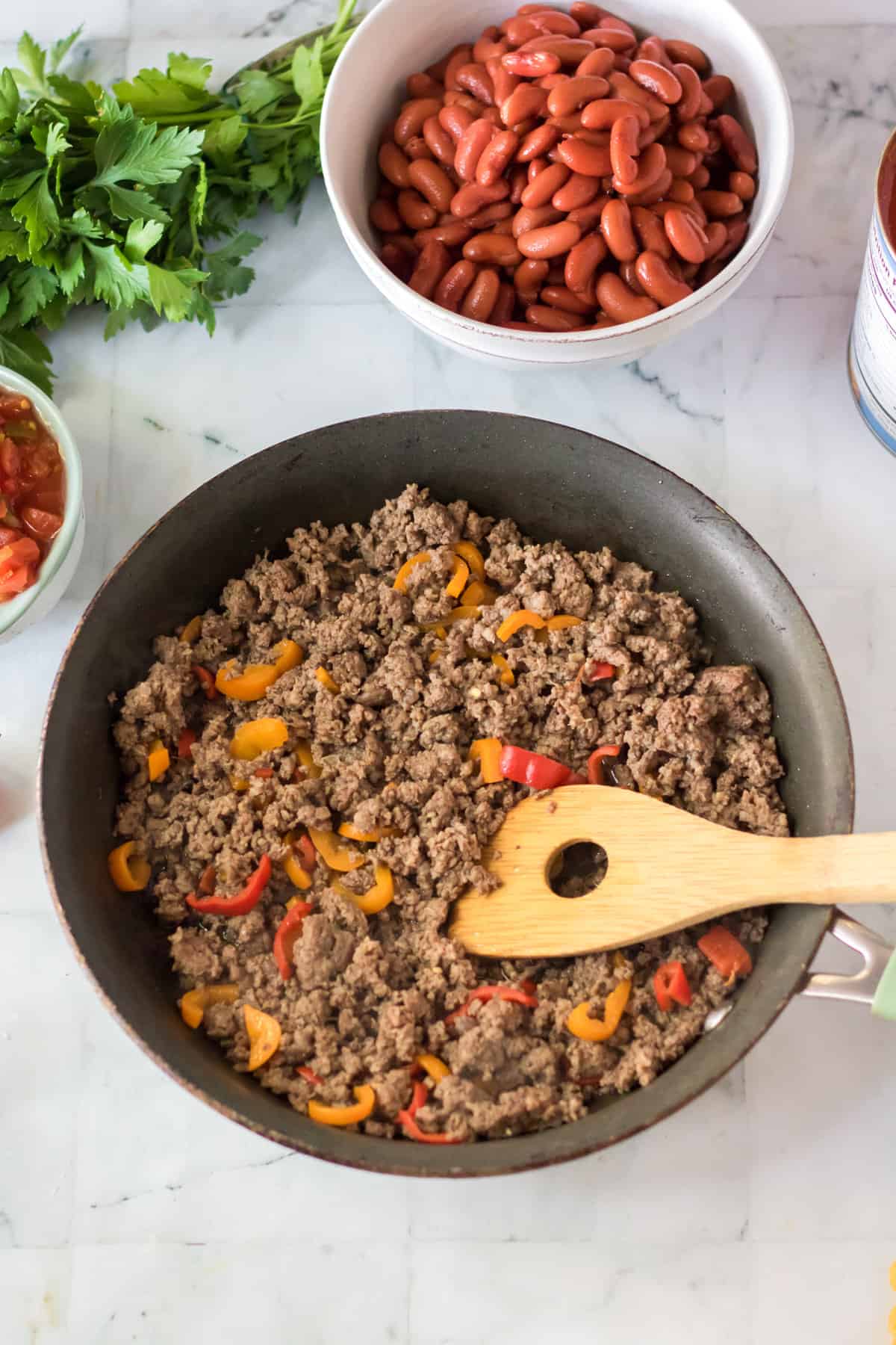 Browned ground beef and bell peppers in a skillet.