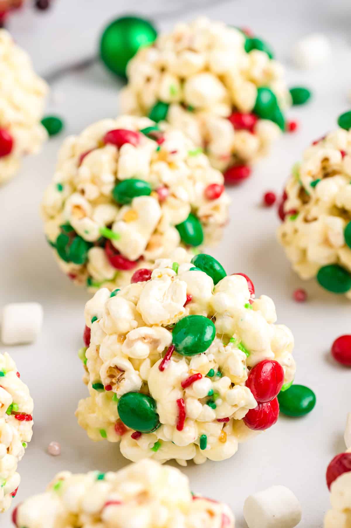 Popcorn balls with m&ms and sprinkles