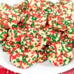 Soft vanilla pudding cookies with Christmas sprinkles on white serving platter