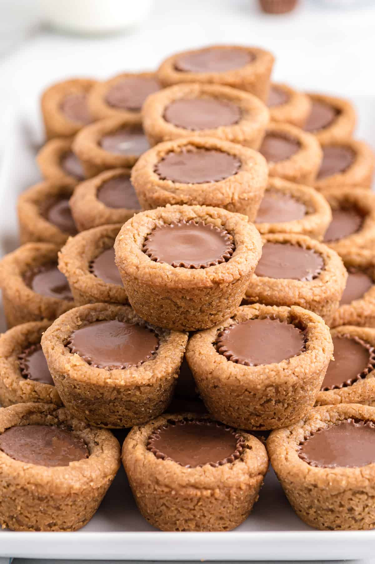 Mini peanut butter cup cookies stacked neatly on serving platter