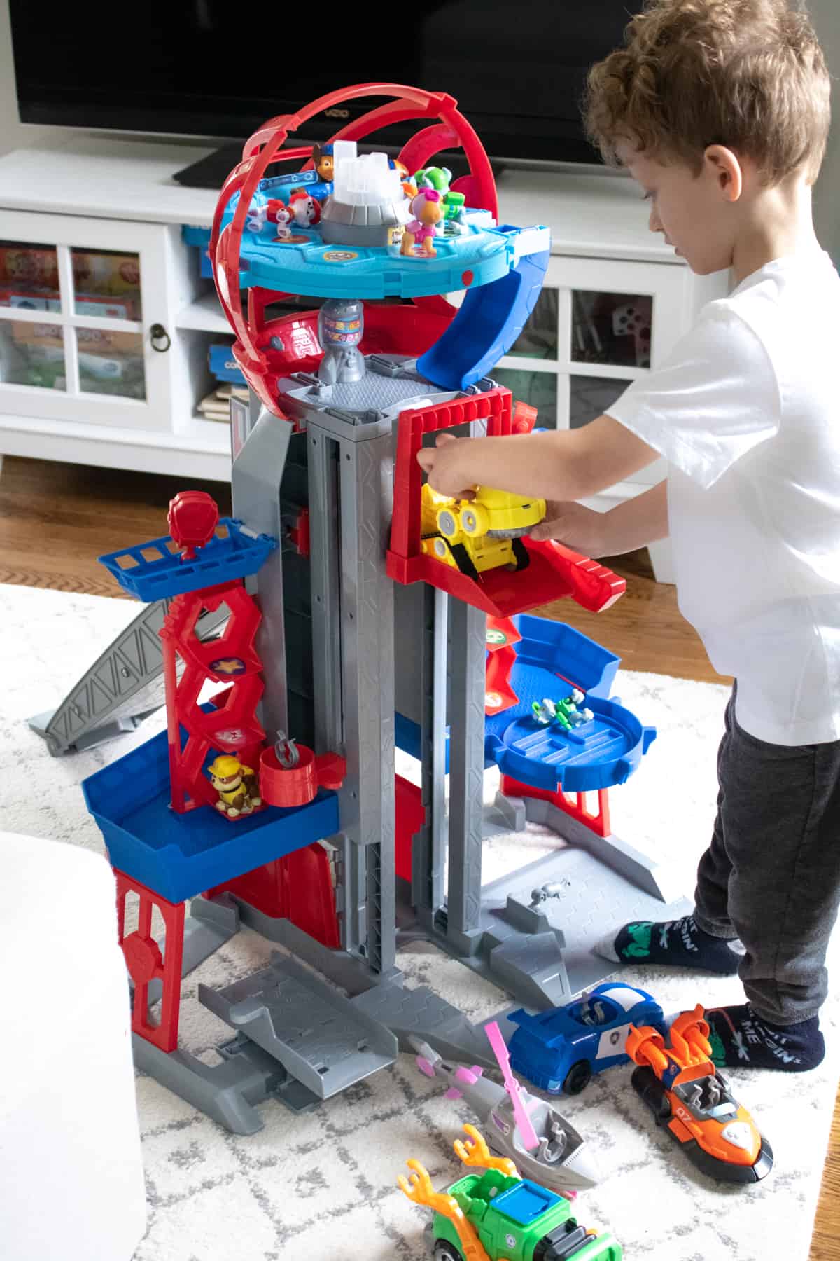 Child playing with the vehicle lift on the The Ultimate City Tower Playset