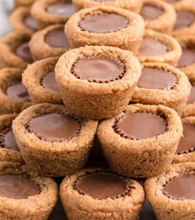 Mini peanut butter cup cookies stacked neatly on serving platter