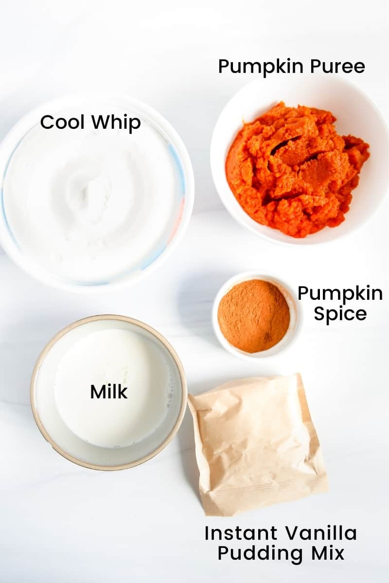 Ingredients on countertop: Cool Whip, pumpkin puree, instant vanilla pudding mix, milk, and pumpkin pie spice