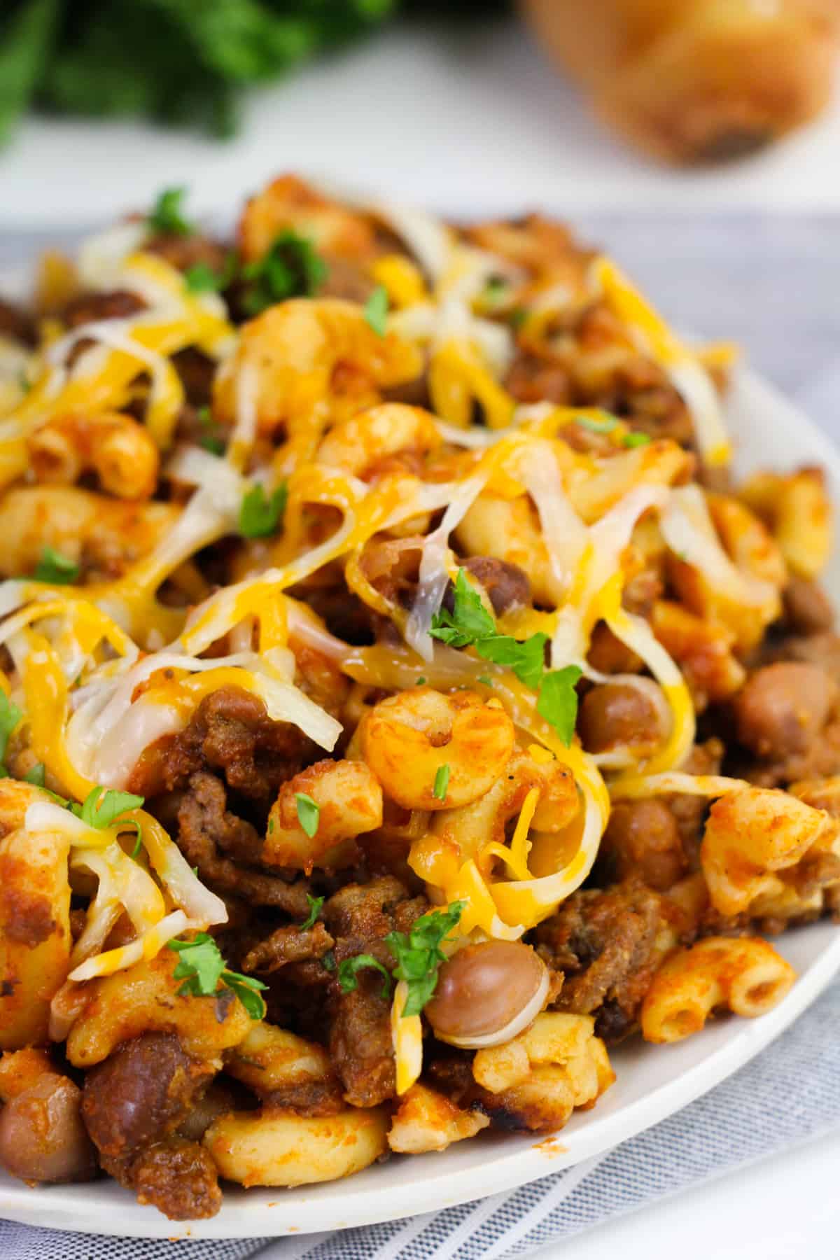 Close up of slow cooker chili mac with ground beef and shredded cheese