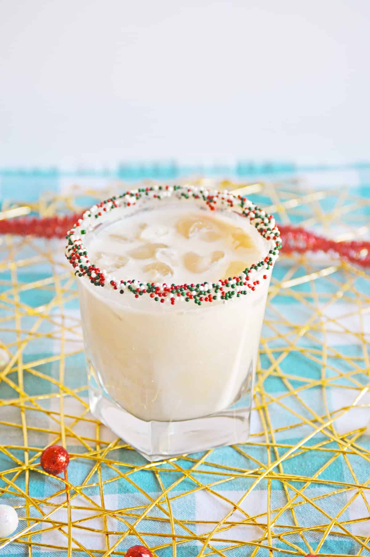 Christmas Cookie Cocktail with vodka in a christmas sprinkle rimmed glass