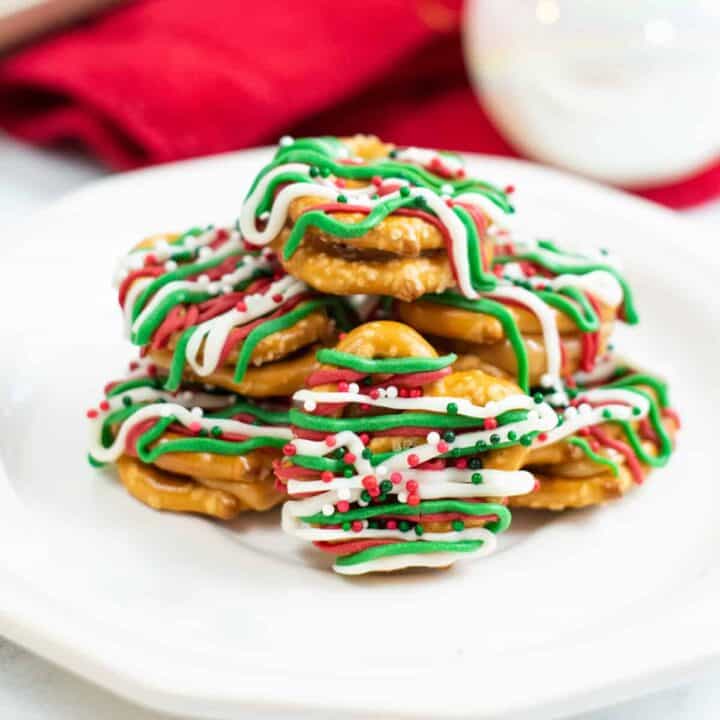 caramel pretzel bites drizzled with green, red, and white chocolate and topped with holiday sprinkles
