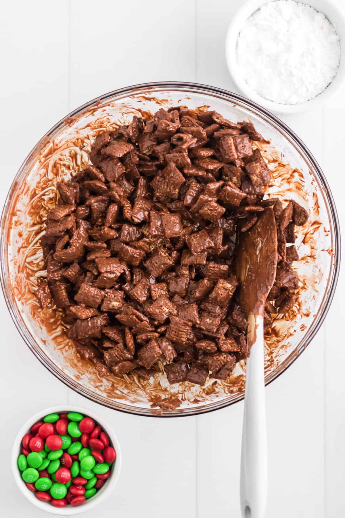 large glass bowl filled with chocolate and peanut butter coated chex cereal