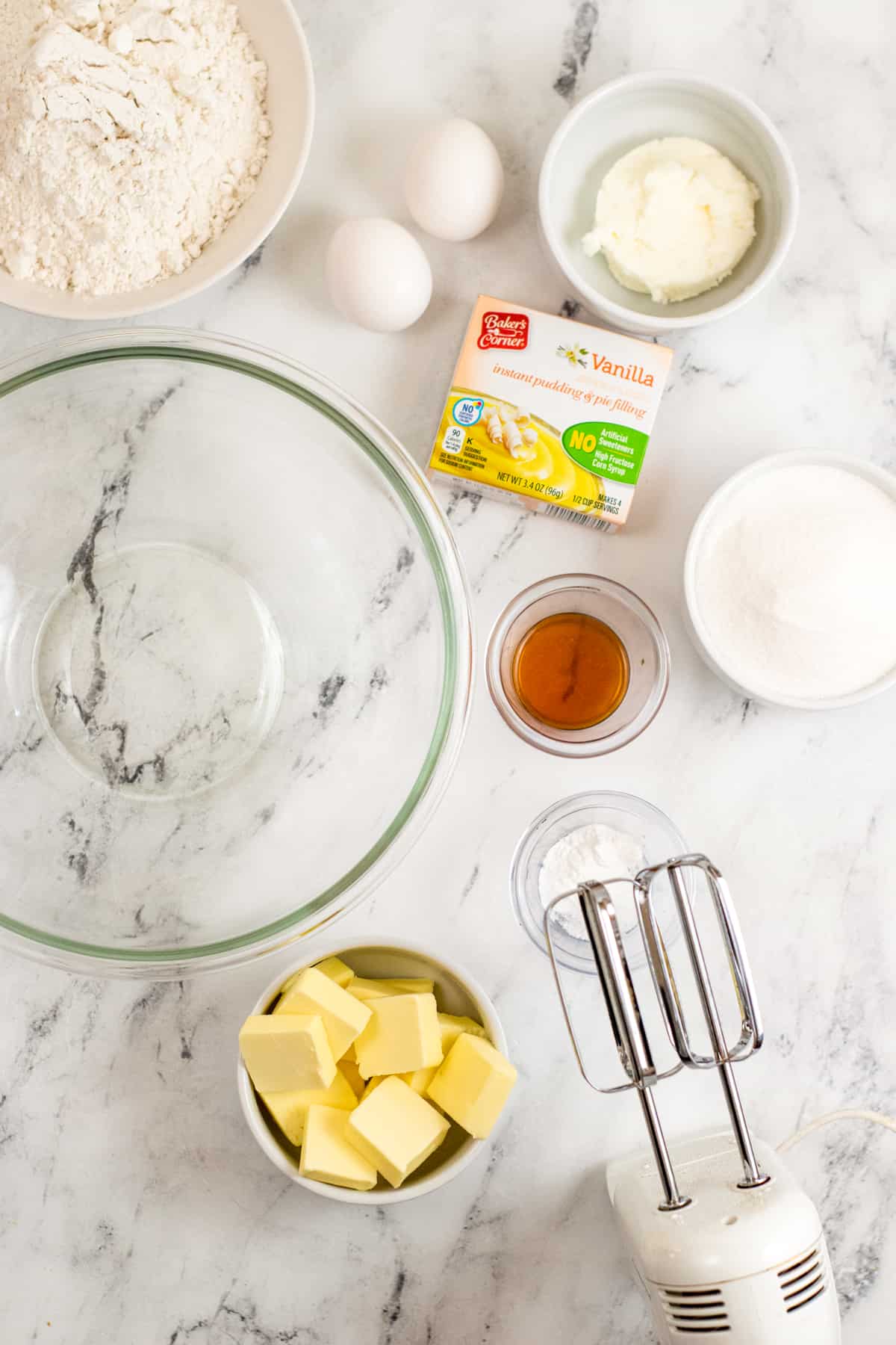 Glass mixing bowl, hand mixer, butter, flour, sugar, shortening, vanilla pudding, 2 eggs, vanilla extract, baking powder, and salt