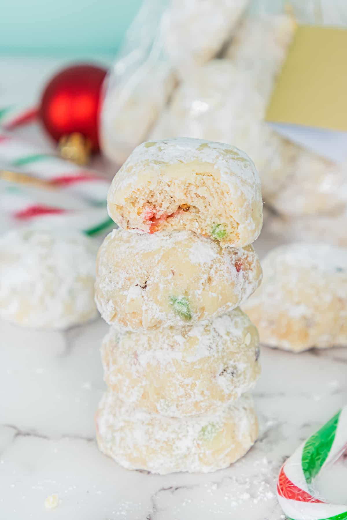 Snowball cookies with pieces of red and green candy canes in them