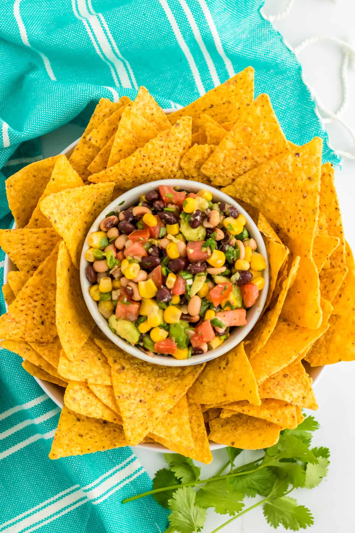 Cowboy Caviar Dip in a bowl surrounded by tortilla chips