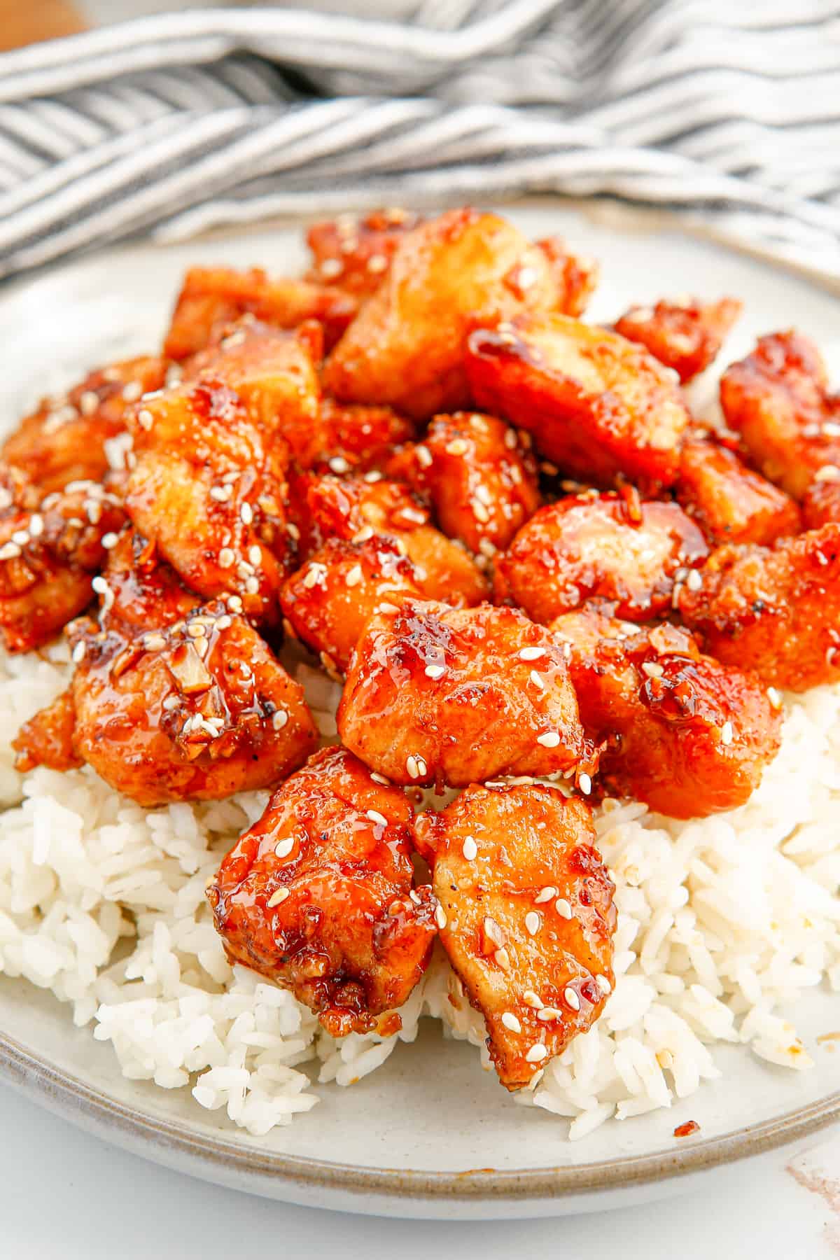 Honey sesame chicken breast pieces served over rice