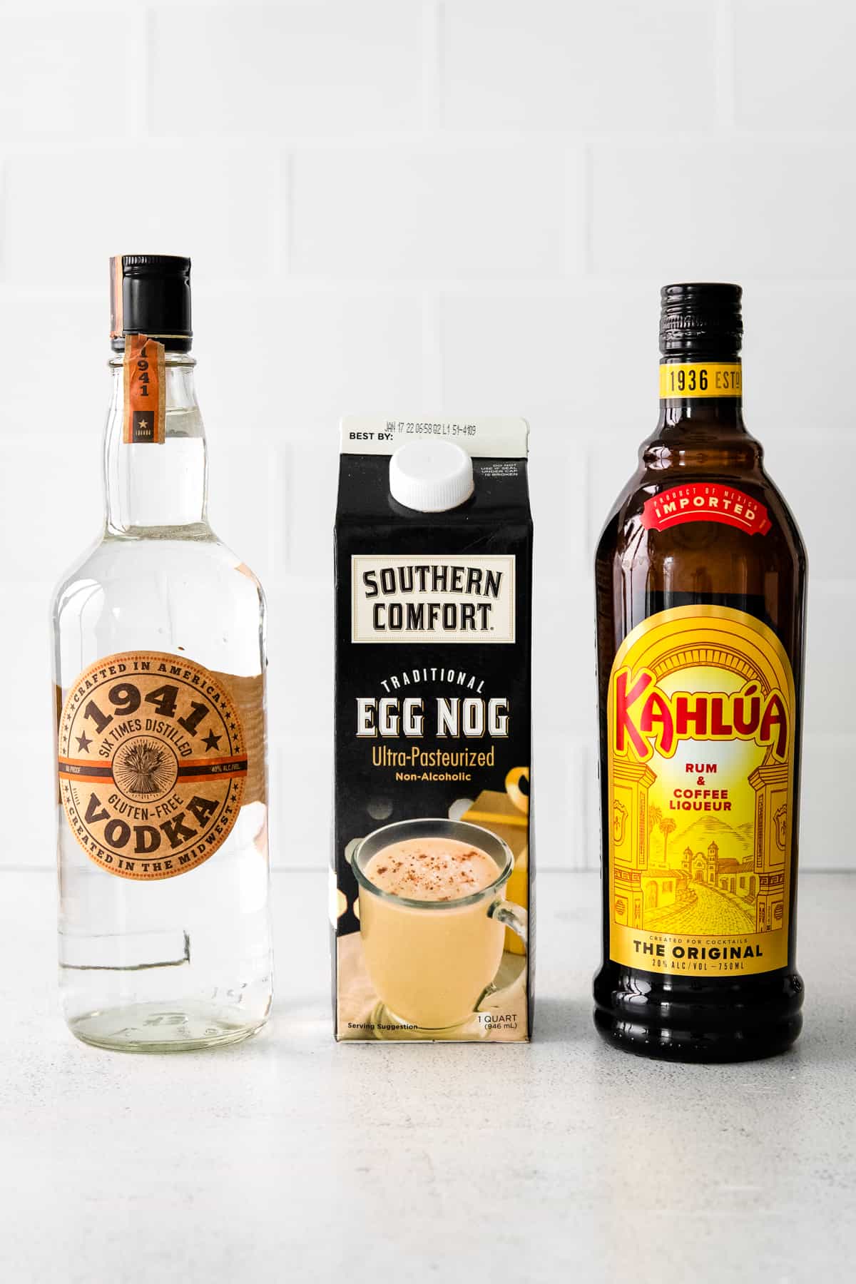 bottle of 1941 vodka, carton of egg nog, and bottle of Kahlua coffee liquor