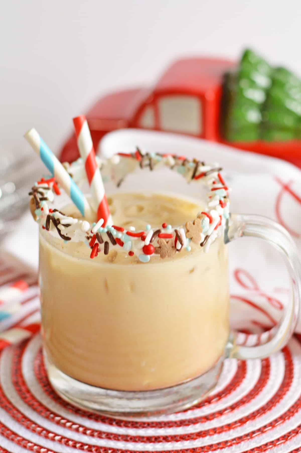 Gingerbread Cookie Cocktail in a glass mug rimmed with vanilla frosting and sprinkles.