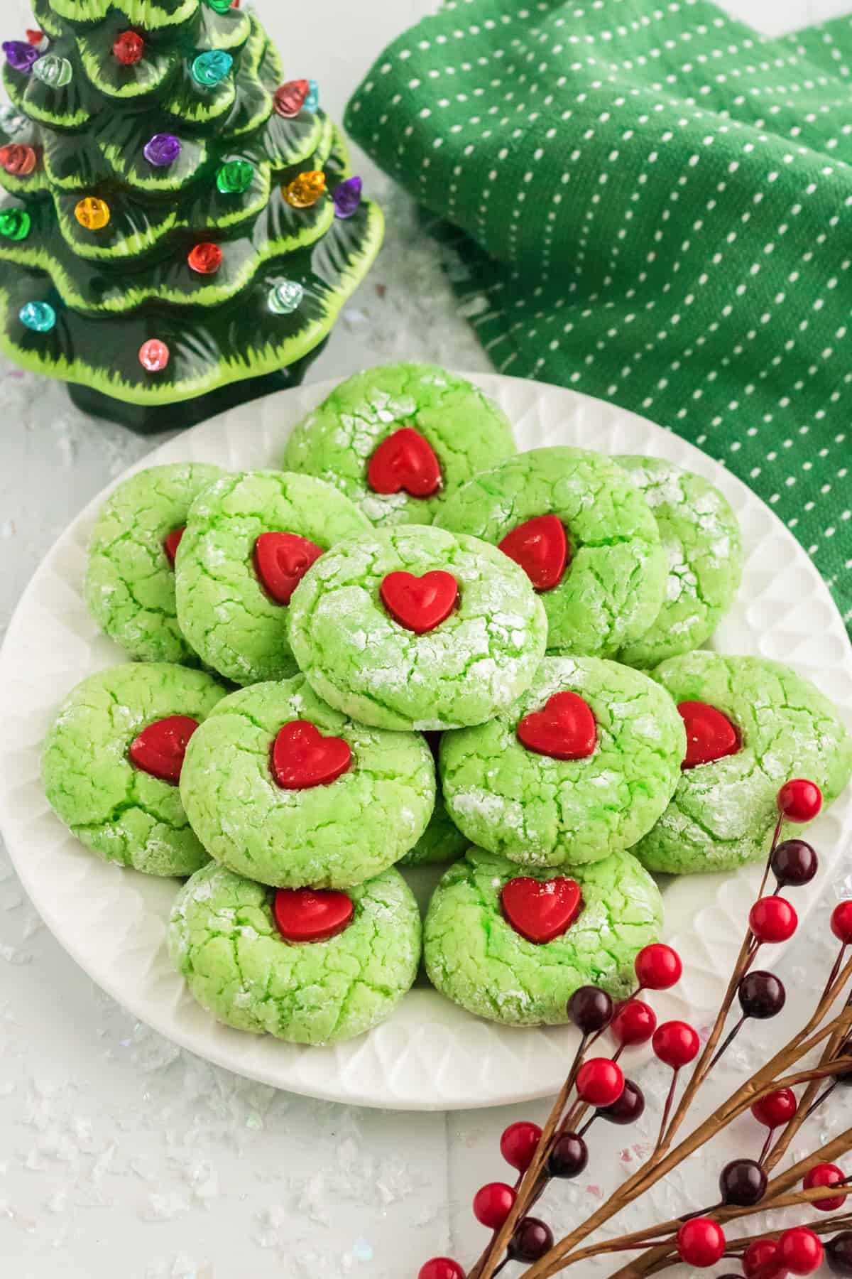 Grinch Cake Mix Cookies decorated with red hearts