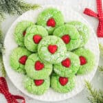 Grinch Cake Mix Cookies decorated with red heart candy in center