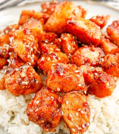 Honey sesame chicken breast pieces served over rice