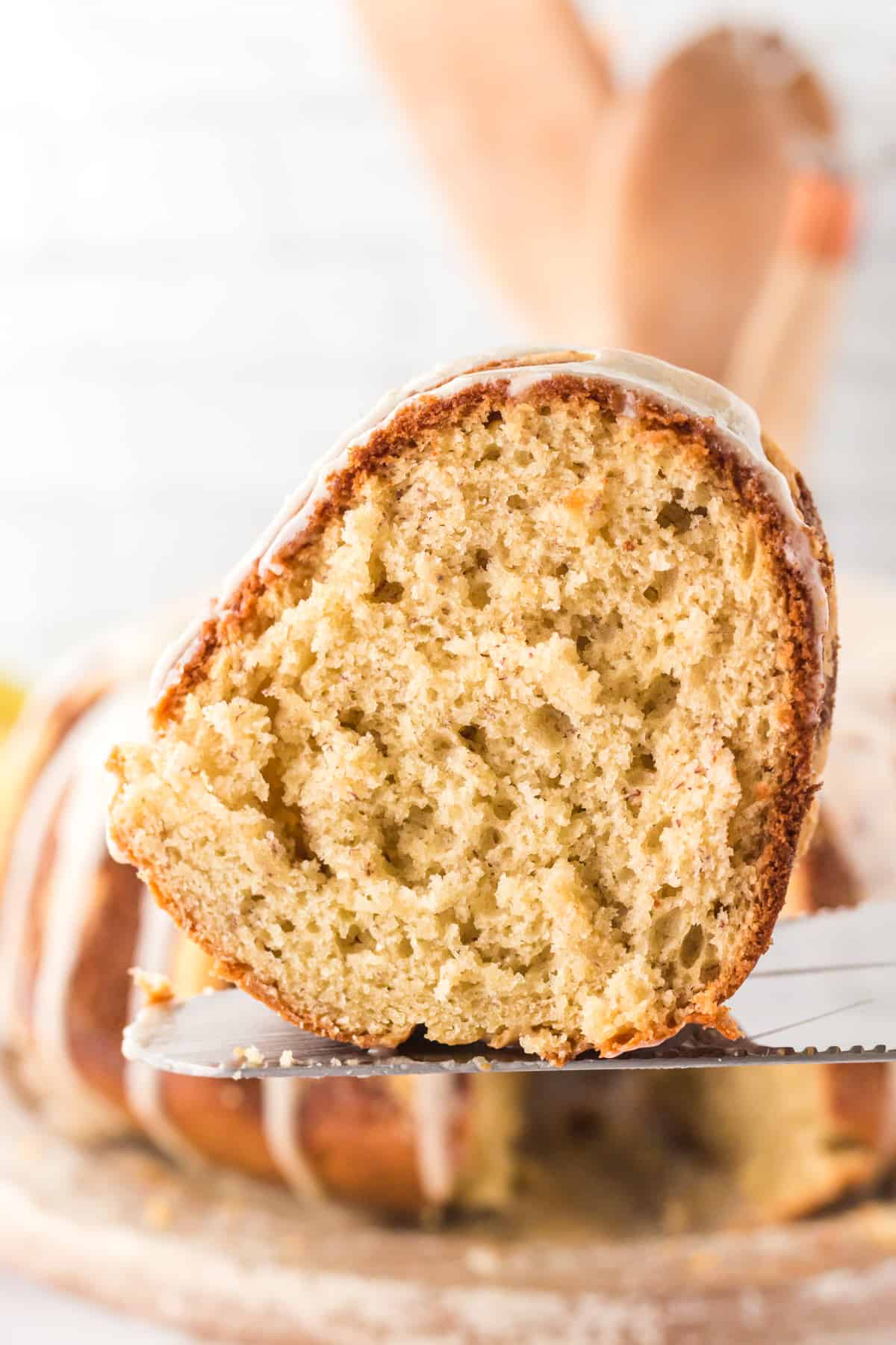 Close up image of moist banana cake slice on cake server