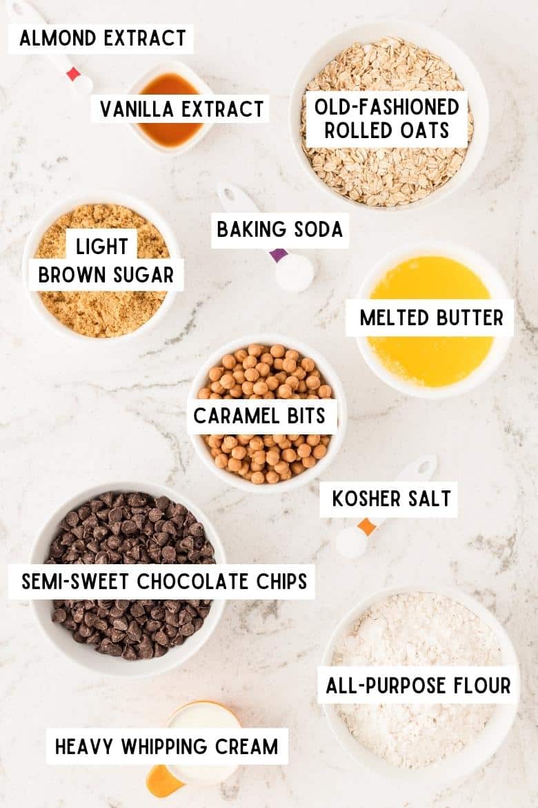 almond extract, vanilla extract, baking soda, kosher salt, semi-sweet chocolate chips, melted butter, brown sugar, caramel bits, heavy whipping cream, all-purpose flour, and old-fashioned rolled oats