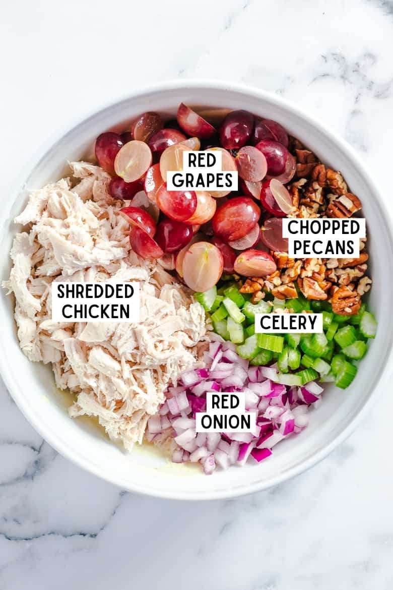 Bowl with the following: halves red grapes, chopped pecans, celery, red onions, and shredded chicken breasts