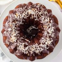 Chocolate coconut bundt cake topped with chocolate ganache and toasted coconut.