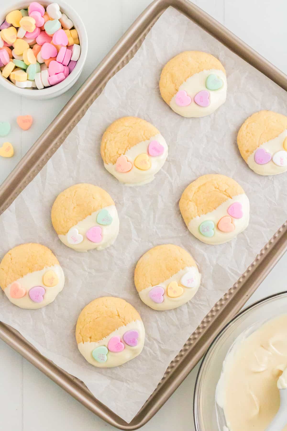 Dipped Valentines Day Conversation Heart Cookies on lined cookie sheet