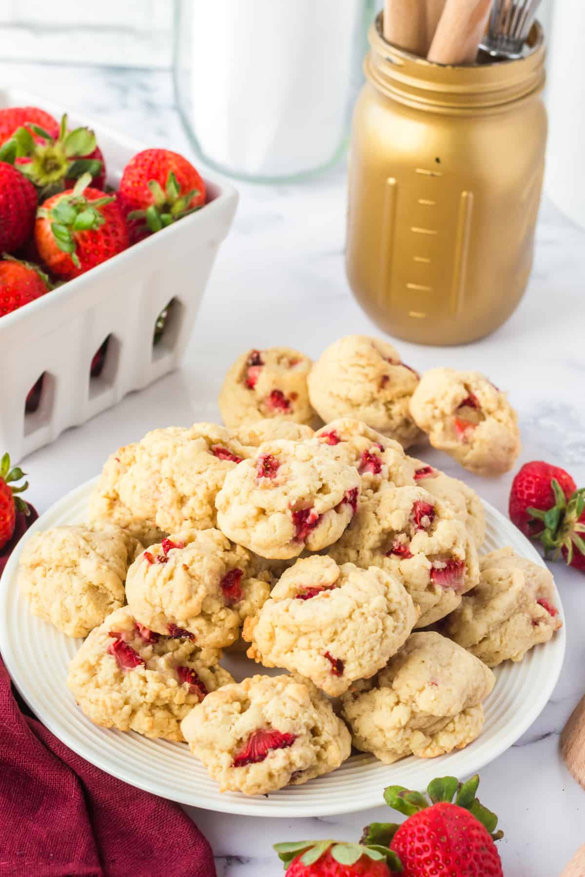 Strawberry Shortcake Cookies on white plate with fresh strawberries in the background