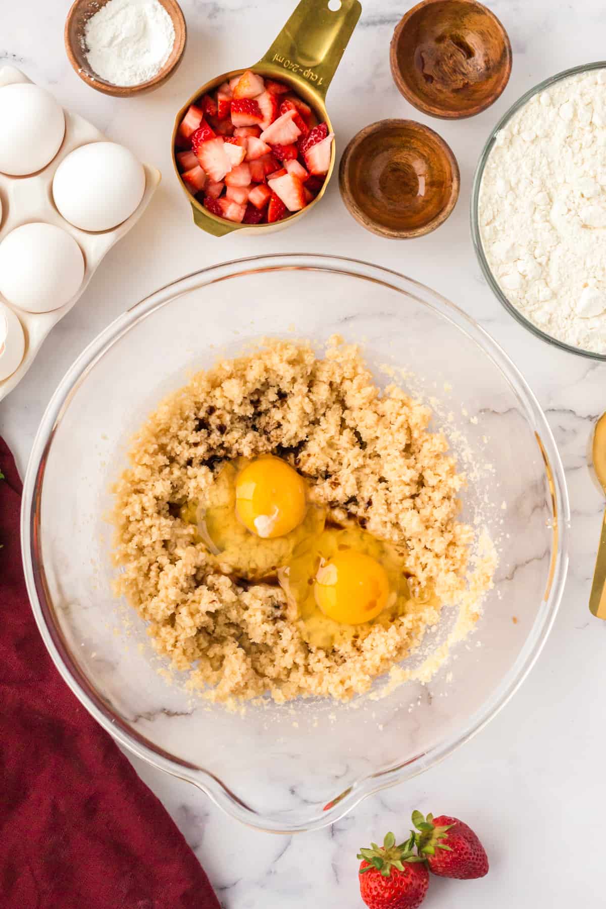 Large mixing bowl with creamed sugar, 2 eggs, and vanilla extract