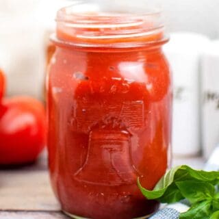 homemade pizza sauce in mason jar on wooden table