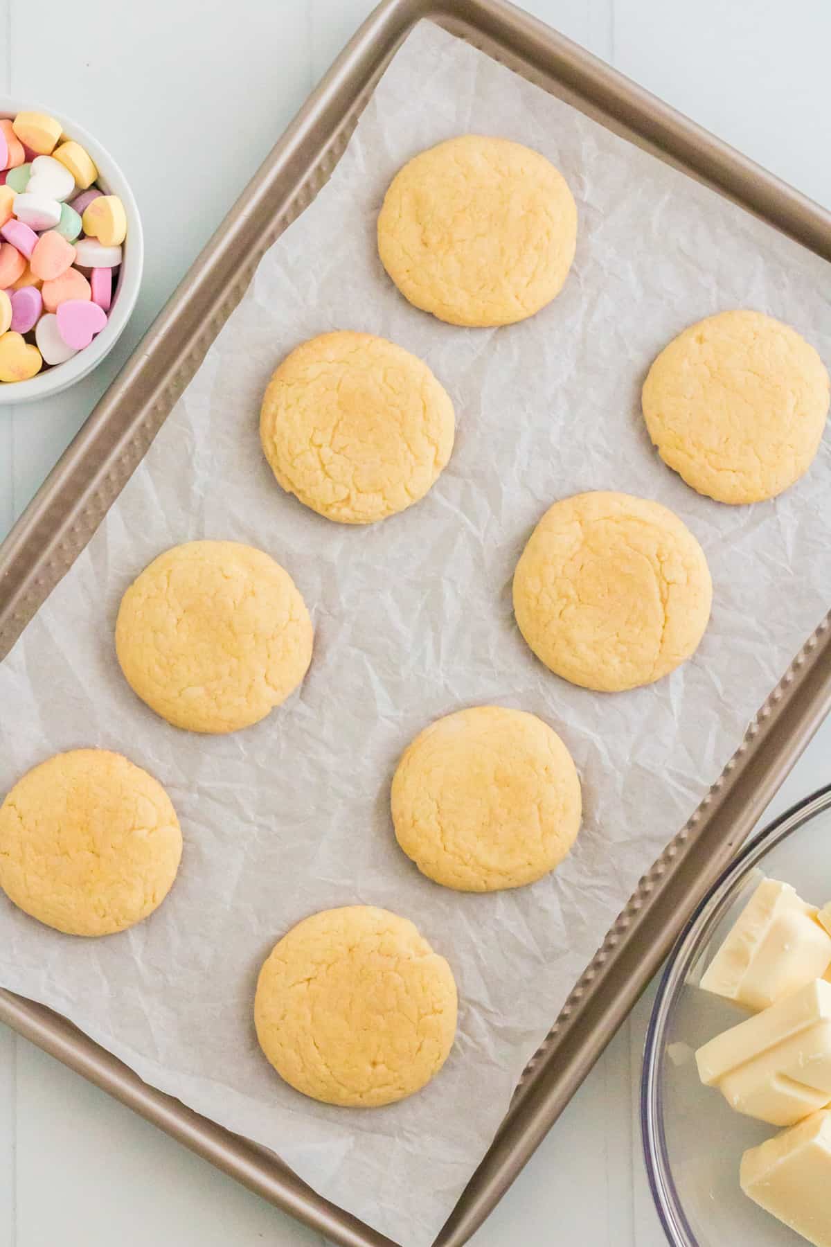 Vanilla cake mix cookies on lined cookie sheet