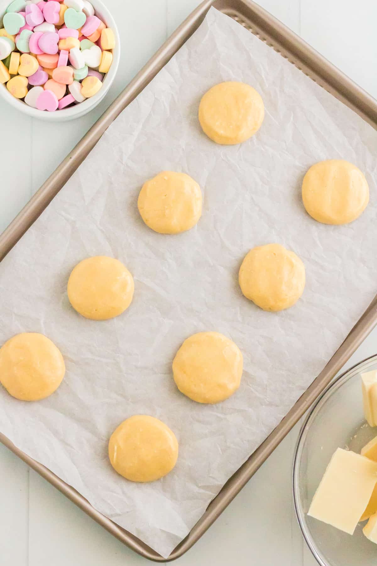 Vanilla cake mix cookie batter on parchment lined baking sheet