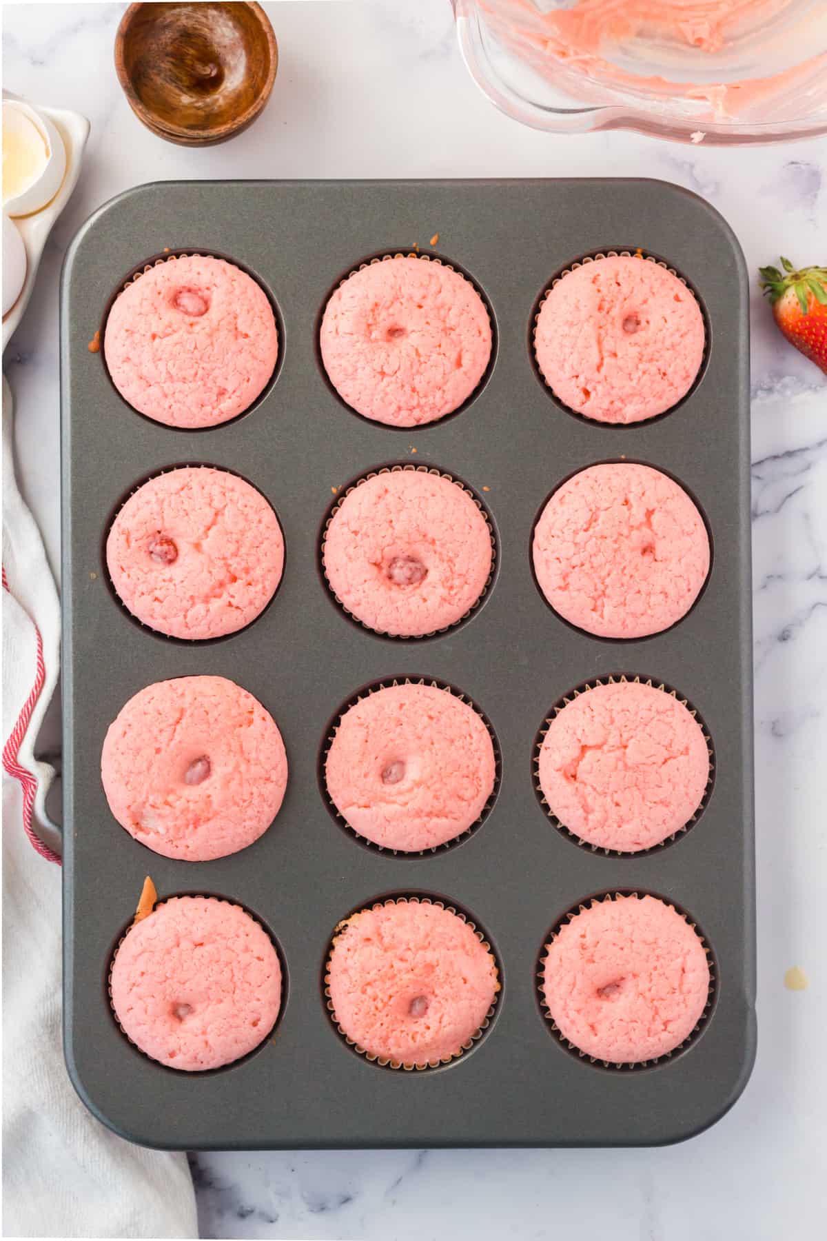 Freshly baked strawberry cupcakes in muffin tin