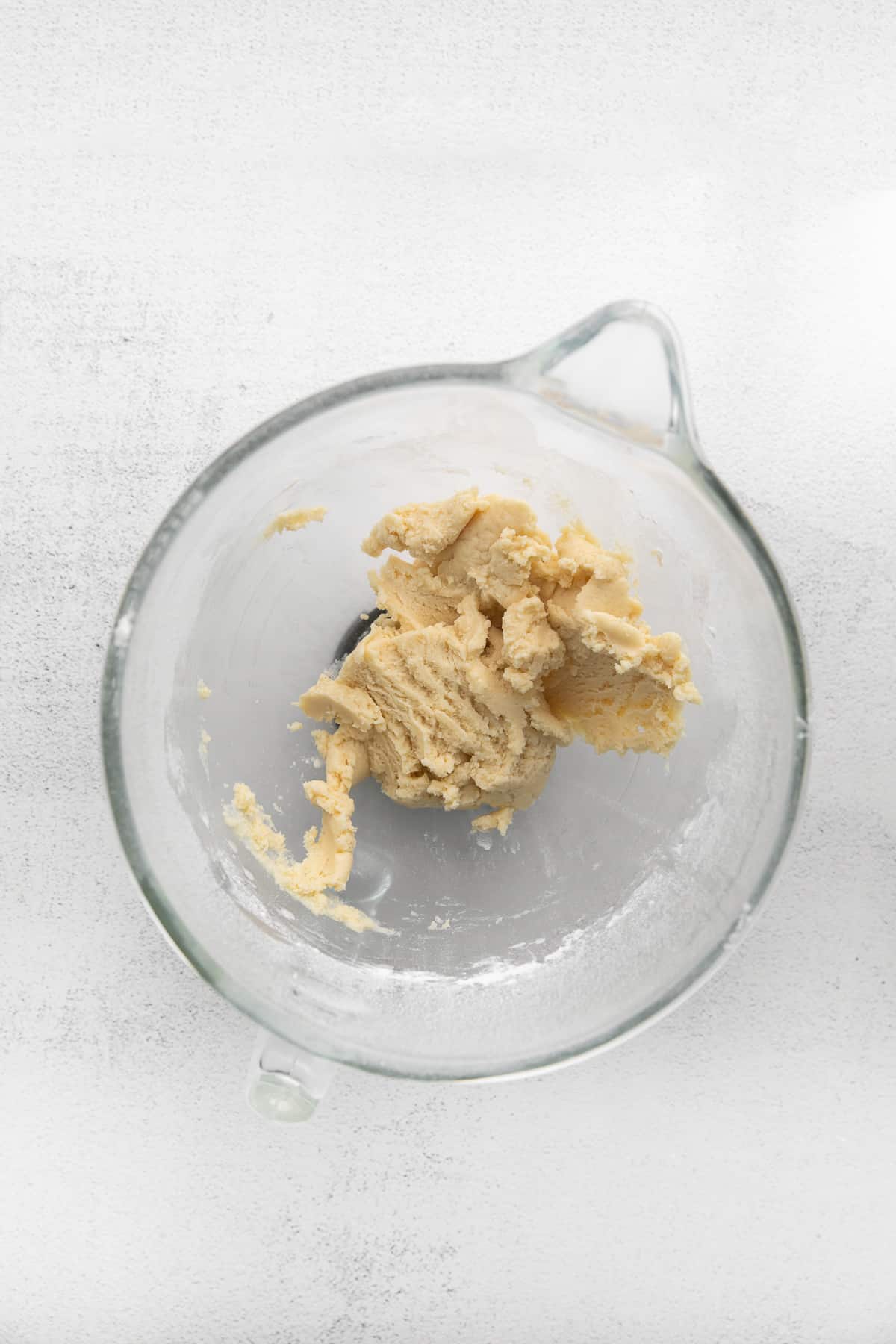 Glass mixing bowl with cookie dough.