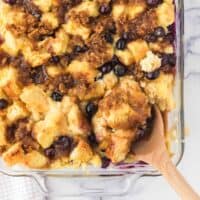 Blueberry French Toast Casserole with spoon scooping out a serving.
