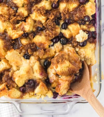 Blueberry French Toast Casserole with spoon scooping out a serving.