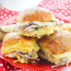 Cuban Slider sandwiches with pork, ham, swiss, pickles, and mustard on hawaiian rolls.
