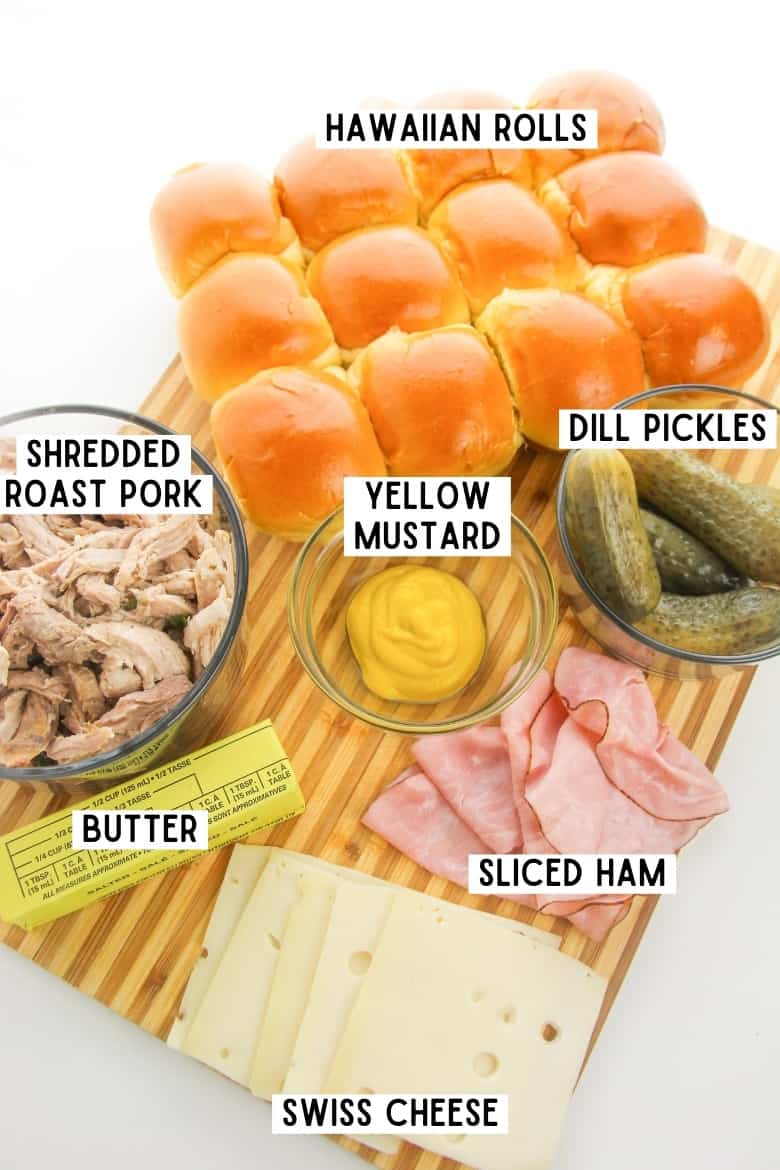 Ingredients for Cuban Sliders: hawaiian rolls, dill pickles, sliced ham, butter, shredded roast pork, Swiss, and yellow mustard.