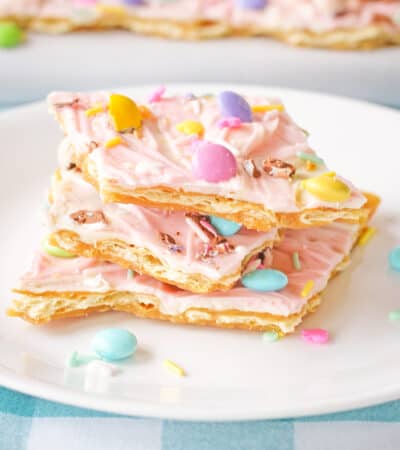 Pink white chocolate Easter bark with pastel M&Ms, Mini Eggs, and sprinkles.