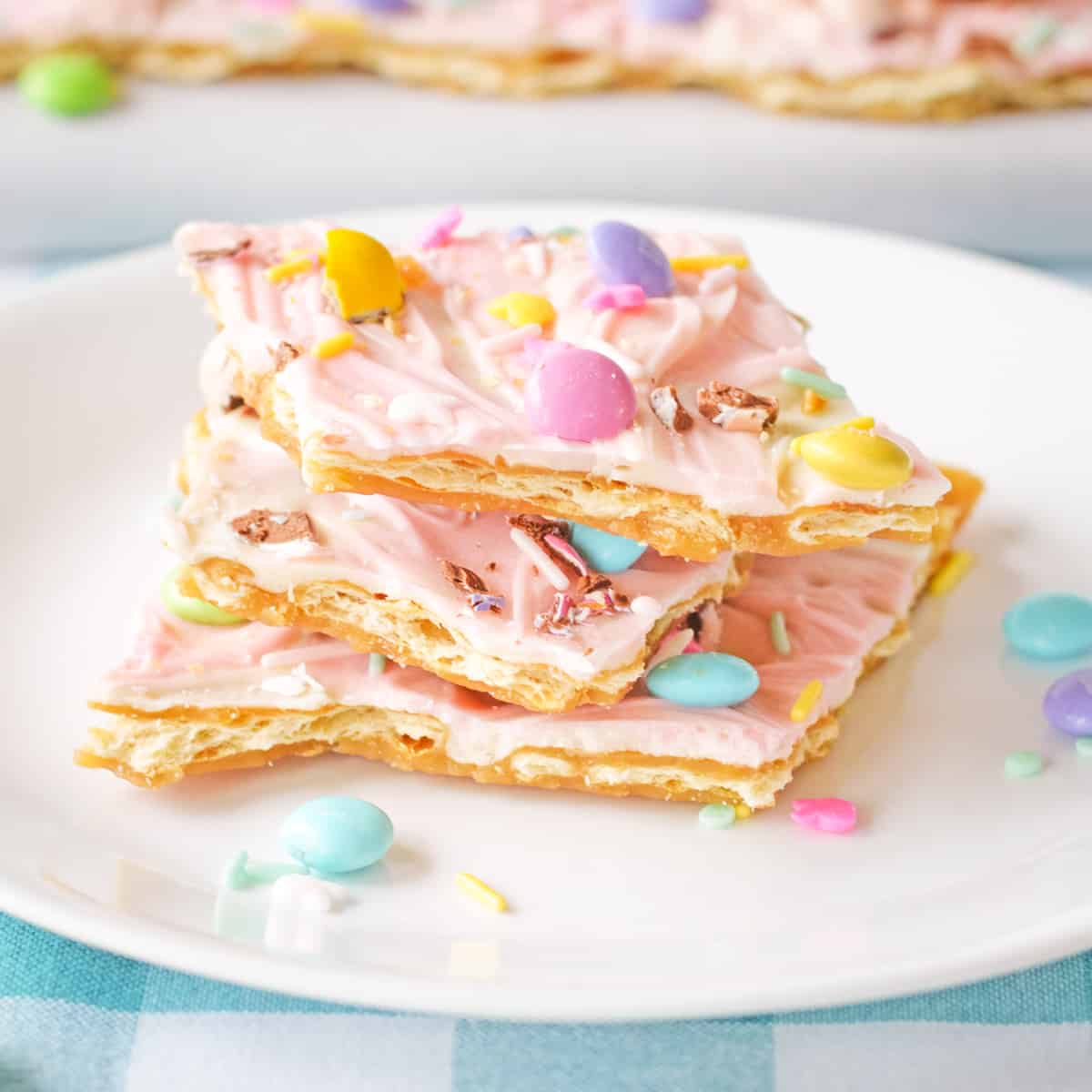 Pink white chocolate Easter bark with pastel M&Ms, Mini Eggs, and sprinkles.