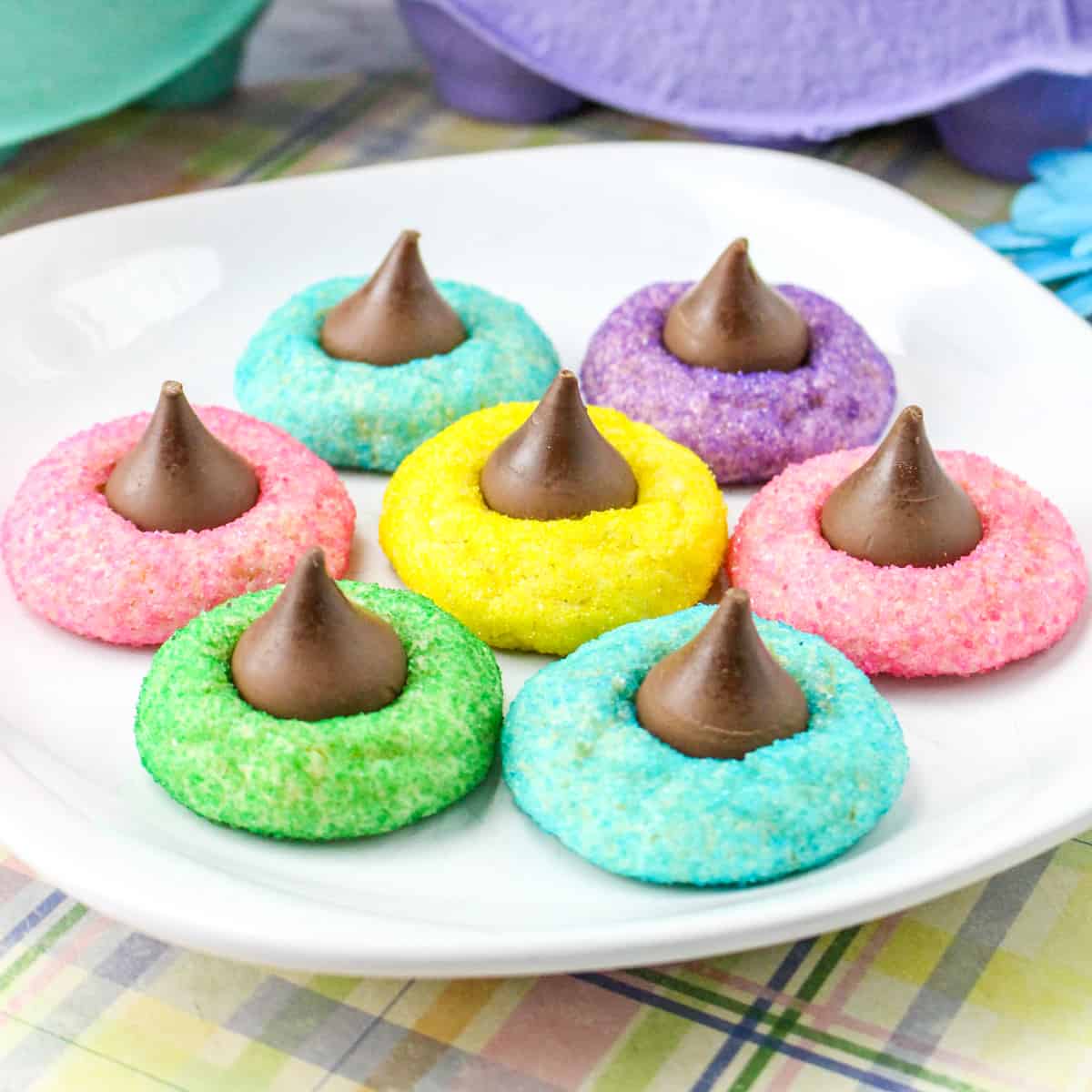 Colorful Easter Blossom Cookies with Hershey Kisses on white plate.